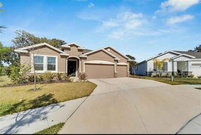 ranch-style home with a front lawn, driveway, stucco siding, and a garage