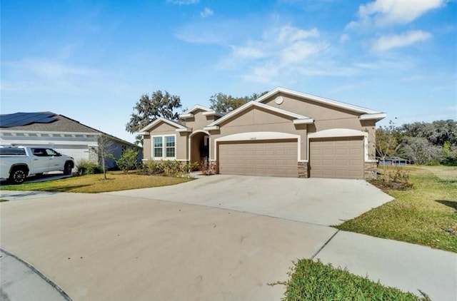 view of front of house with stone siding, driveway, a garage, and a front lawn