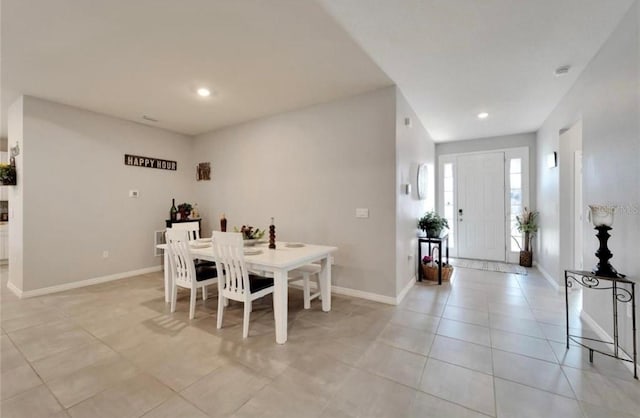 dining area with light tile patterned floors, baseboards, and recessed lighting