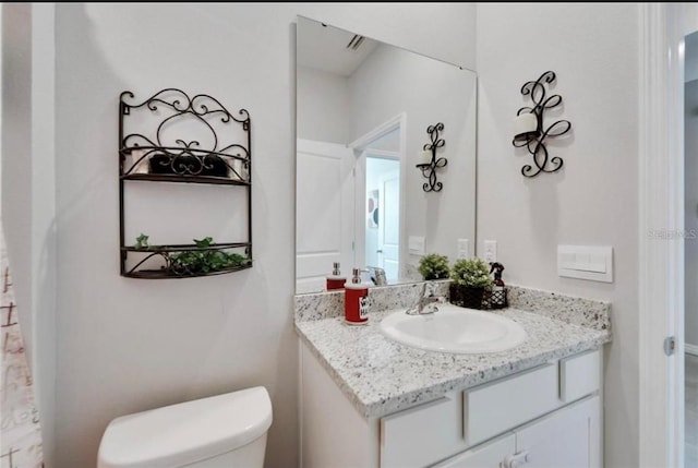 bathroom featuring toilet and vanity