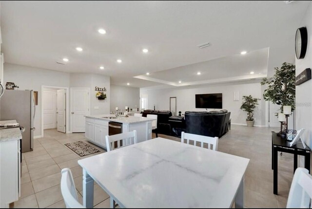 dining space featuring visible vents, baseboards, recessed lighting, a raised ceiling, and light tile patterned floors