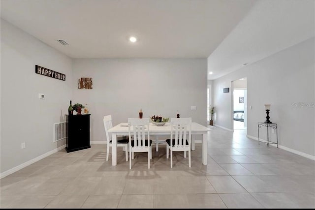 unfurnished dining area with baseboards, visible vents, and light tile patterned floors