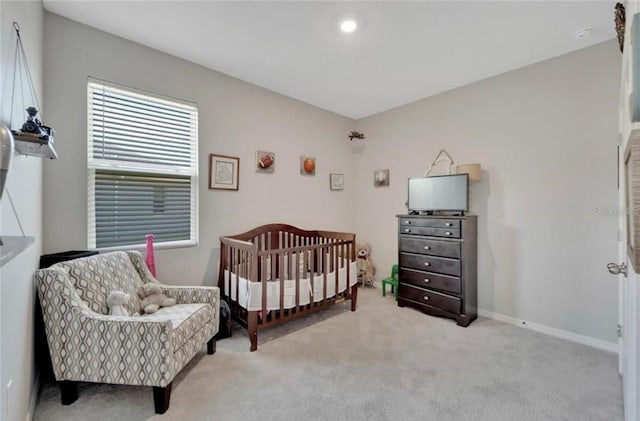 bedroom with baseboards and carpet