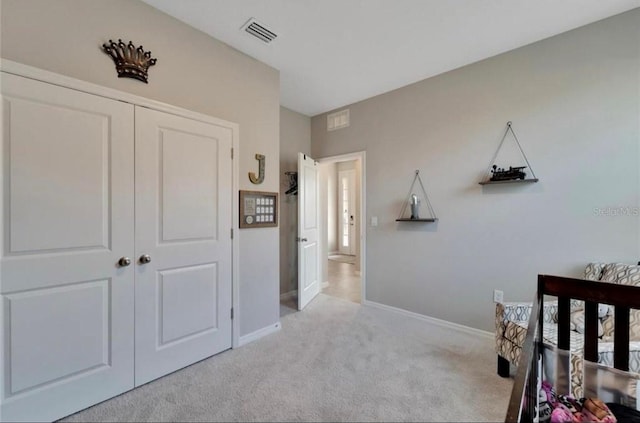 carpeted bedroom featuring a closet, baseboards, and visible vents