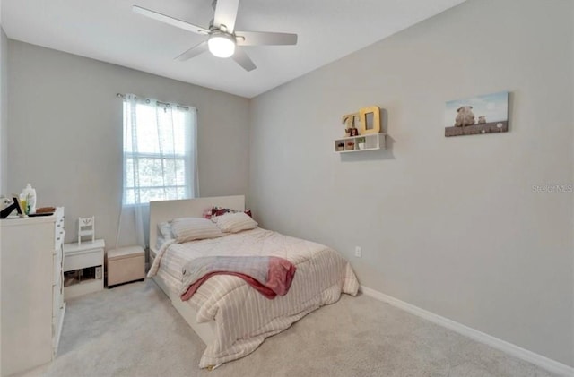 carpeted bedroom featuring baseboards and ceiling fan