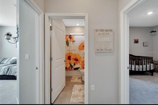 hallway featuring carpet flooring