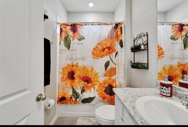 full bath featuring toilet, shower / bath combination with curtain, and vanity