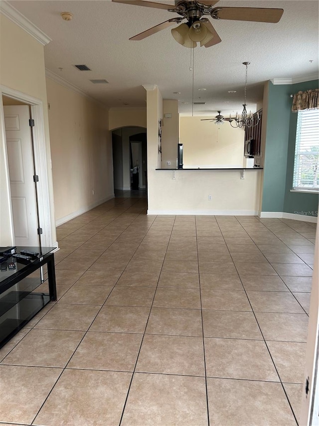 15 Ocean Crest Way Unit 1335, Palm Coast, FL 32137 - interior space featuring light tile patterned floors, ornamental molding, ceiling fan with notable chandelier, a textured ceiling, and arched walkways