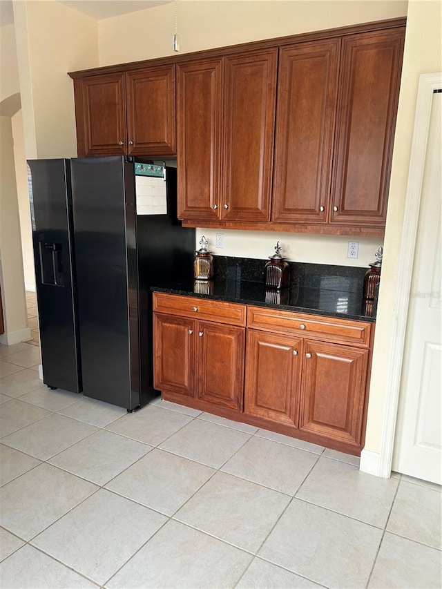 15 Ocean Crest Way Unit 1335, Palm Coast, FL 32137 - kitchen featuring black fridge with ice dispenser, brown cabinets, dark stone countertops, and light tile patterned floors