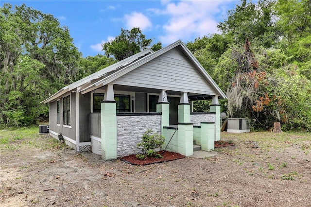 bungalow-style home with a porch and central AC