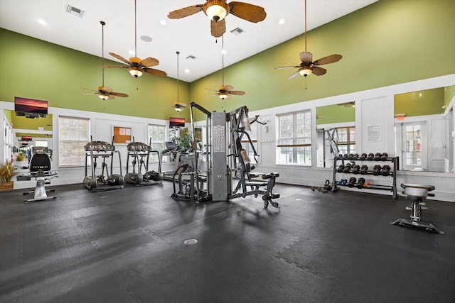 exercise room with visible vents, high vaulted ceiling, and a healthy amount of sunlight