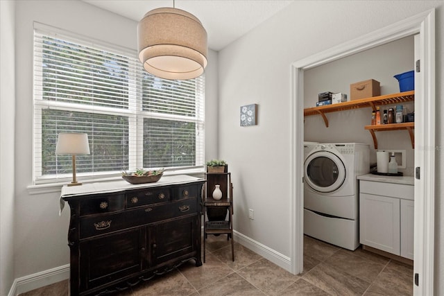 45 Riverview Bnd S Unit 1926, Palm Coast, FL 32137 - washroom with washer / clothes dryer, healthy amount of natural light, light tile patterned floors, and baseboards