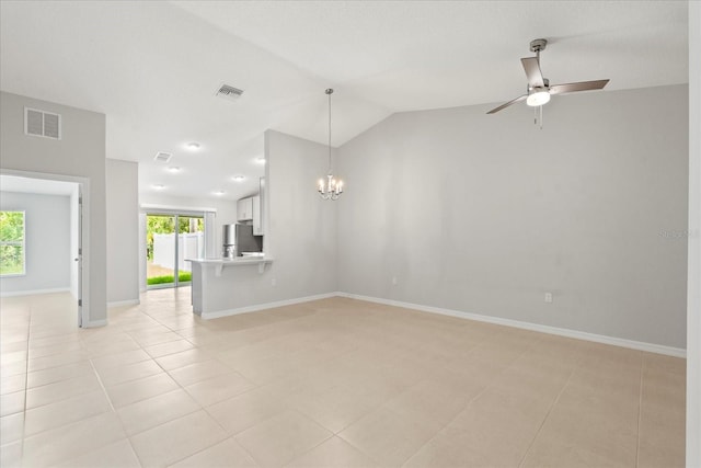 29 Secretary Trl, Palm Coast, FL 32164 - unfurnished living room with ceiling fan with notable chandelier, baseboards, vaulted ceiling, and visible vents