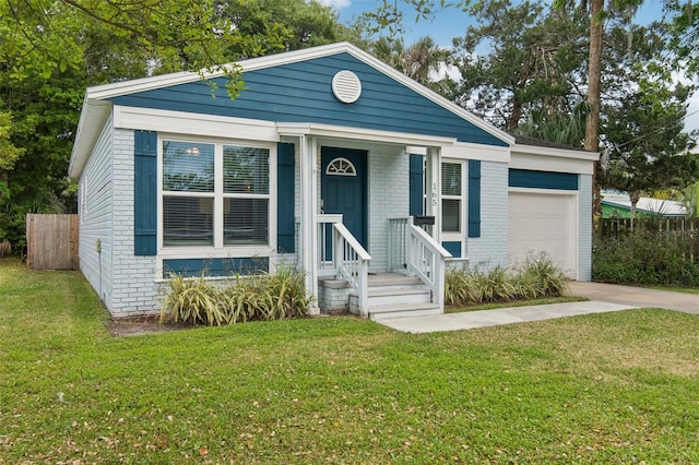 view of front facade with driveway, brick siding, fence, and a front lawn