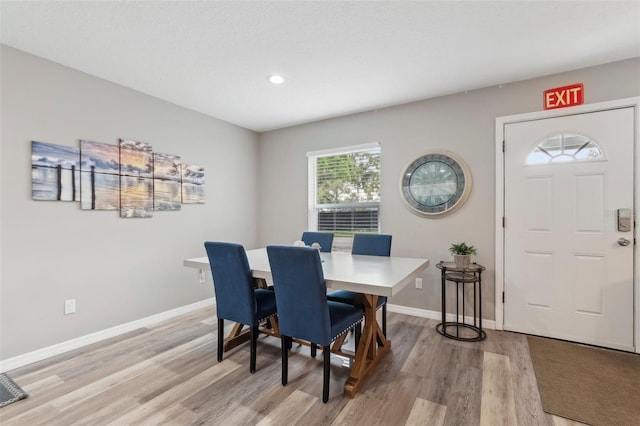 dining room with baseboards and light wood finished floors
