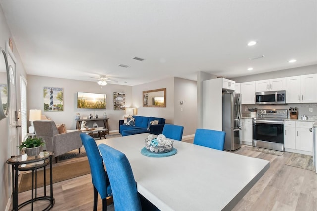 dining room featuring a ceiling fan, recessed lighting, light wood finished floors, and visible vents