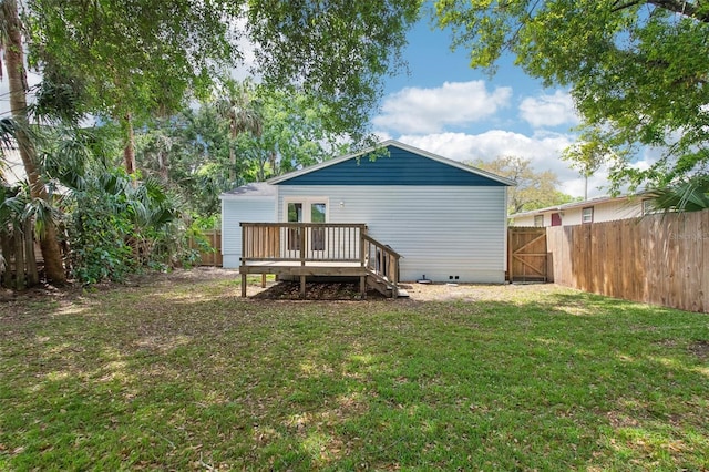 back of house with a fenced backyard, a lawn, a wooden deck, and crawl space