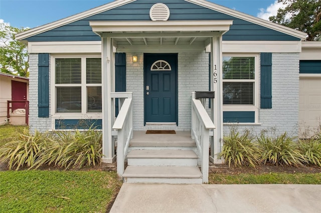 entrance to property with brick siding