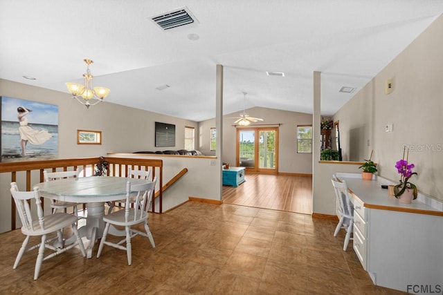 1951 N Daytona Ave, Flagler Beach, FL 32136 - dining area with ceiling fan with notable chandelier, baseboards, vaulted ceiling, and visible vents