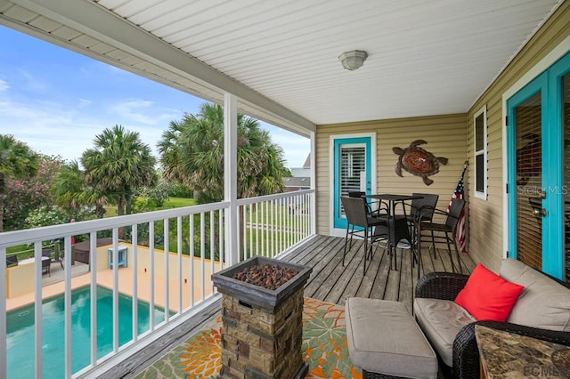 1951 N Daytona Ave, Flagler Beach, FL 32136 - wooden terrace featuring an outdoor pool and outdoor dining space