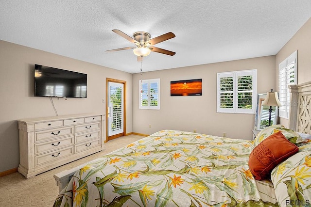 1951 N Daytona Ave, Flagler Beach, FL 32136 - bedroom with light carpet, a textured ceiling, access to outside, baseboards, and ceiling fan