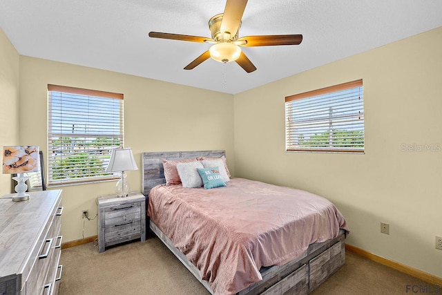 1951 N Daytona Ave, Flagler Beach, FL 32136 - bedroom featuring baseboards, multiple windows, and light carpet