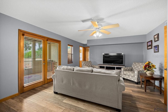 1951 N Daytona Ave, Flagler Beach, FL 32136 - living area featuring baseboards, a textured ceiling, visible vents, a ceiling fan, and wood finished floors