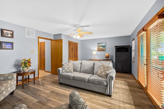 1951 N Daytona Ave, Flagler Beach, FL 32136 - living room with baseboards, visible vents, light wood-style floors, and a ceiling fan