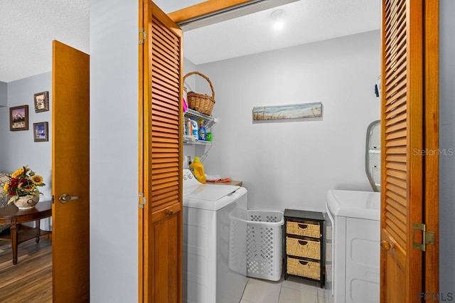1951 N Daytona Ave, Flagler Beach, FL 32136 - washroom with tile patterned flooring, separate washer and dryer, laundry area, and a textured ceiling
