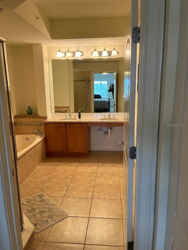 102 Yacht Harbor Dr Unit 375, Palm Coast, FL 32137 - bathroom with a garden tub, a sink, double vanity, ensuite bath, and tile patterned flooring