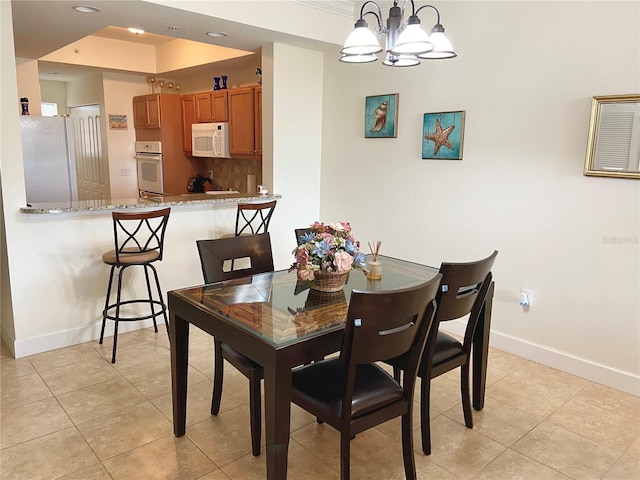 102 Yacht Harbor Dr Unit 375, Palm Coast, FL 32137 - dining room with recessed lighting, baseboards, a notable chandelier, and light tile patterned floors