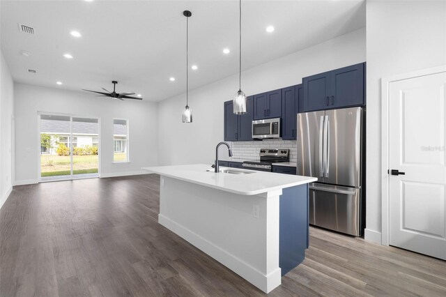 6 Rainbow Ln, Palm Coast, FL 32164 - kitchen with appliances with stainless steel finishes, decorative backsplash, wood finished floors, recessed lighting, and blue cabinets