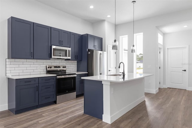 6 Rainbow Ln, Palm Coast, FL 32164 - kitchen with stainless steel appliances, light countertops, backsplash, light wood-type flooring, and recessed lighting