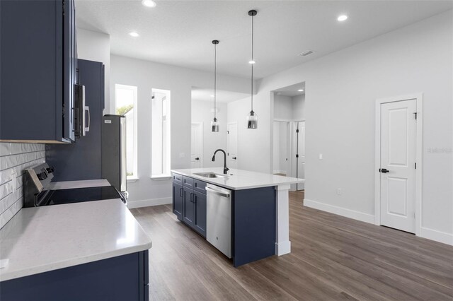 6 Rainbow Ln, Palm Coast, FL 32164 - kitchen featuring blue cabinets, stainless steel appliances, backsplash, dark wood-style flooring, and light countertops