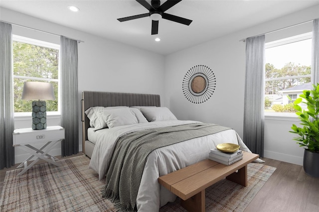 6 Rainbow Ln, Palm Coast, FL 32164 - bedroom with multiple windows, wood finished floors, recessed lighting, and ceiling fan