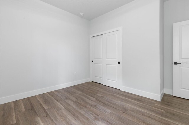 6 Rainbow Ln, Palm Coast, FL 32164 - unfurnished bedroom featuring wood finished floors and a closet