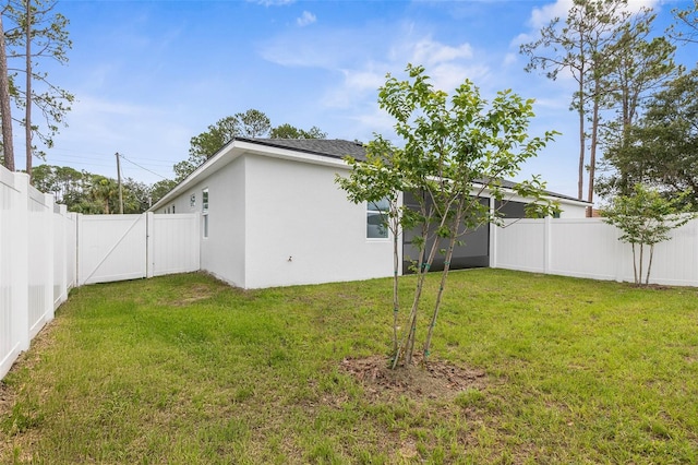 6 Rainbow Ln, Palm Coast, FL 32164 - back of property featuring a fenced backyard, a gate, and stucco siding