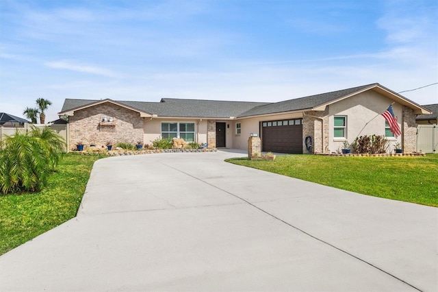 single story home with driveway, stucco siding, an attached garage, brick siding, and a front lawn