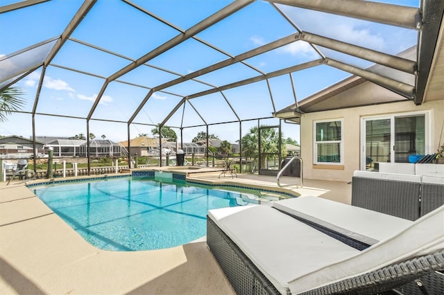 outdoor pool with a lanai, outdoor lounge area, and a patio area