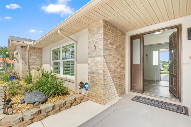 property entrance featuring brick siding
