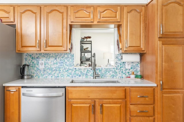 kitchen featuring stainless steel dishwasher, light countertops, a sink, and tasteful backsplash