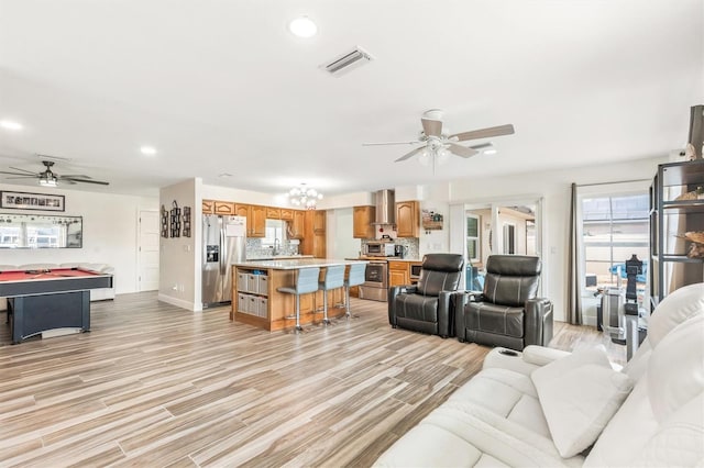 living area featuring light wood-style flooring, visible vents, recessed lighting, and a ceiling fan