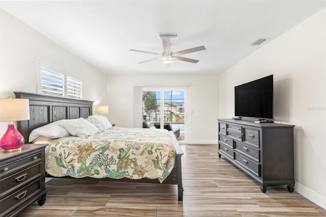 bedroom with baseboards, access to exterior, visible vents, and light wood-style floors