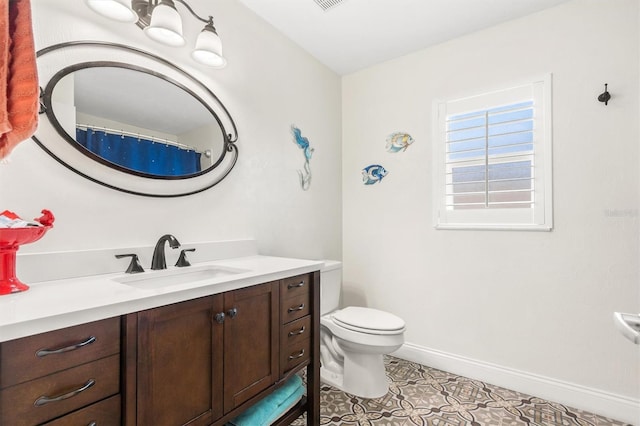 bathroom featuring tile patterned floors, toilet, vanity, baseboards, and visible vents