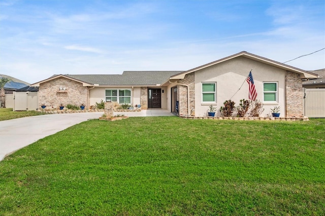 ranch-style home featuring stucco siding, a gate, fence, and a front lawn
