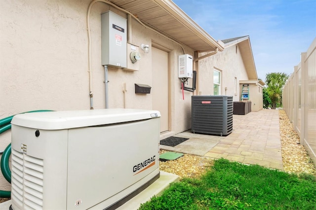 exterior space featuring stucco siding, fence, cooling unit, and a patio