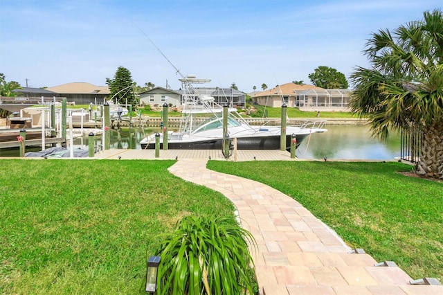 view of dock featuring a lawn, a water view, boat lift, and a residential view