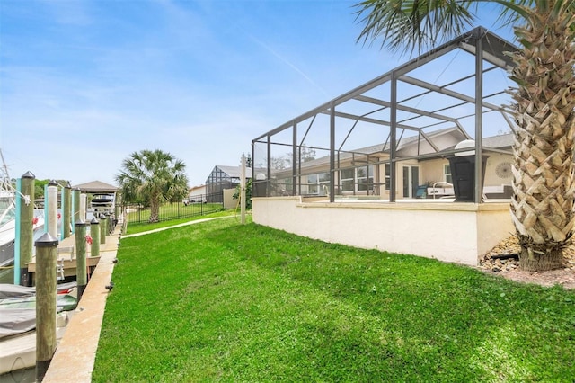 view of yard with a lanai and fence