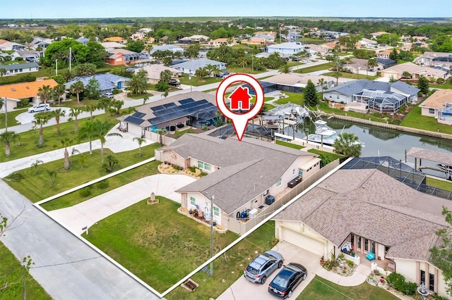 drone / aerial view featuring a residential view and a water view