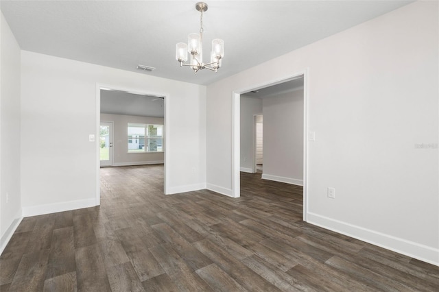 12 Squanto Pl, Palm Coast, FL 32164 - unfurnished room featuring a chandelier, dark wood-style floors, and baseboards